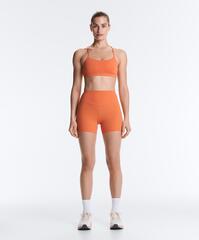 Oysho Спортивный бюстгальтер Comfortlux с перекрещивающимися бретелями и легкой поддержкой, линялый оранжевый