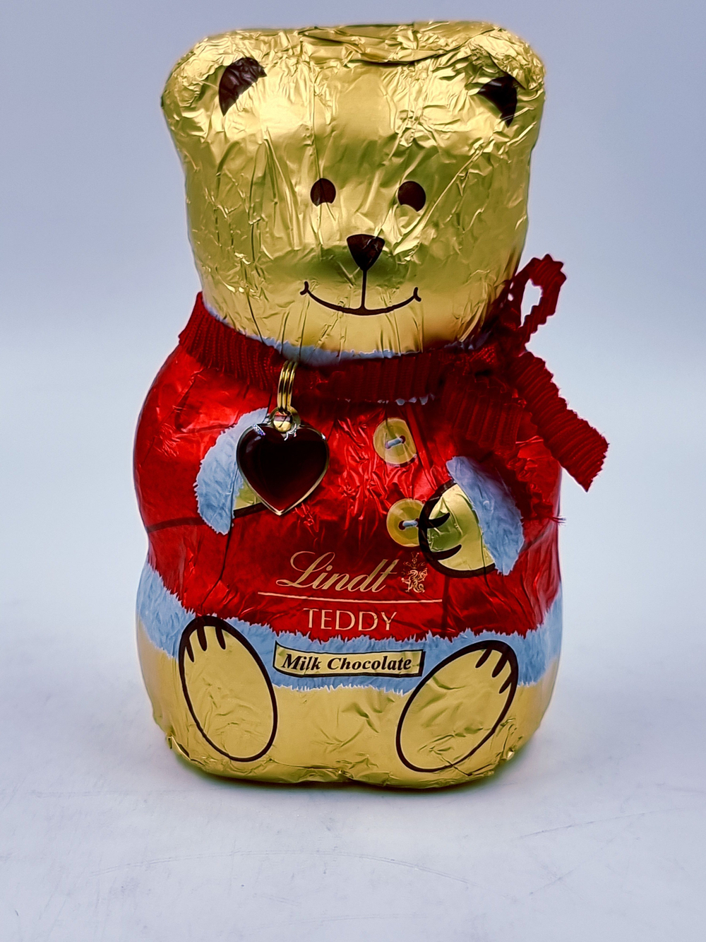 Lindt Teddy Шоколад молочный в форме Мишки, красный/розовый 100 г 1 шт (Германия)