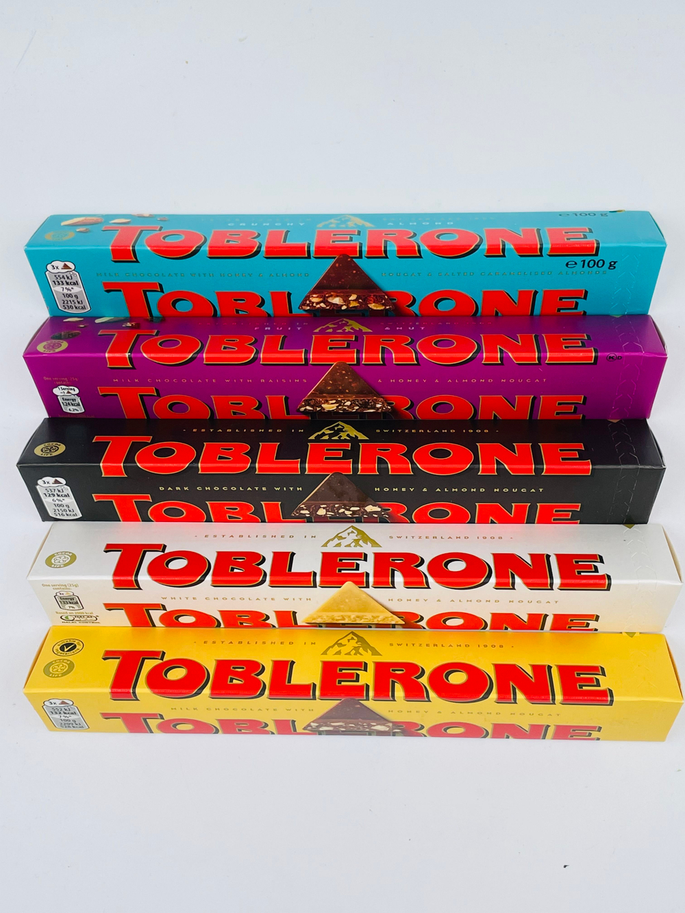 Toblerone ассорти из 5 видов темный+белый+молочный шоколад, мед, нуга, соленая карамель, изюм (6х100 г) 600 г (Швейцария)