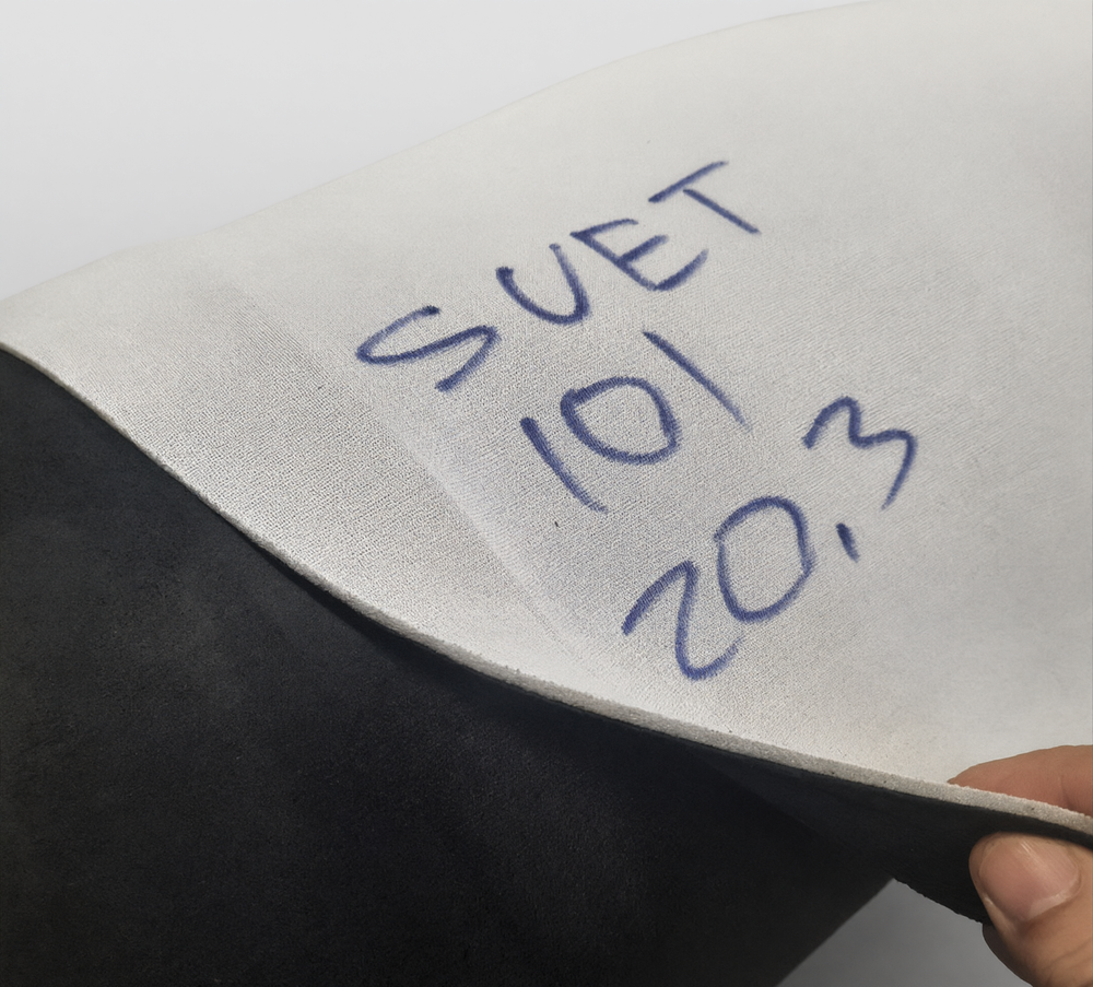 Автоткань алькантара SUET 101 с отогнутым краем листа — черный бархатистый ворс лицевой стороны и маркировка артикула на изнанке