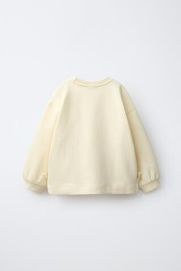 ZARA ТОЛСТОВКА С БАНТАМИ И СЕРДЦЕМ, ЦВЕТ СЛИВОЧНОГО МАСЛА