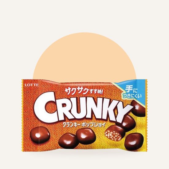 Шоколадное драже Lotte Crunky с хрустящим рисом — упаковка на фирменном фоне OH MY GEEK