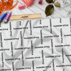 Ткань бязь стильная клетка из чёрных надписей на бежевом фоне